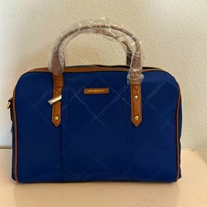 Vera Bradley purse with dark blue body and brown leather trim